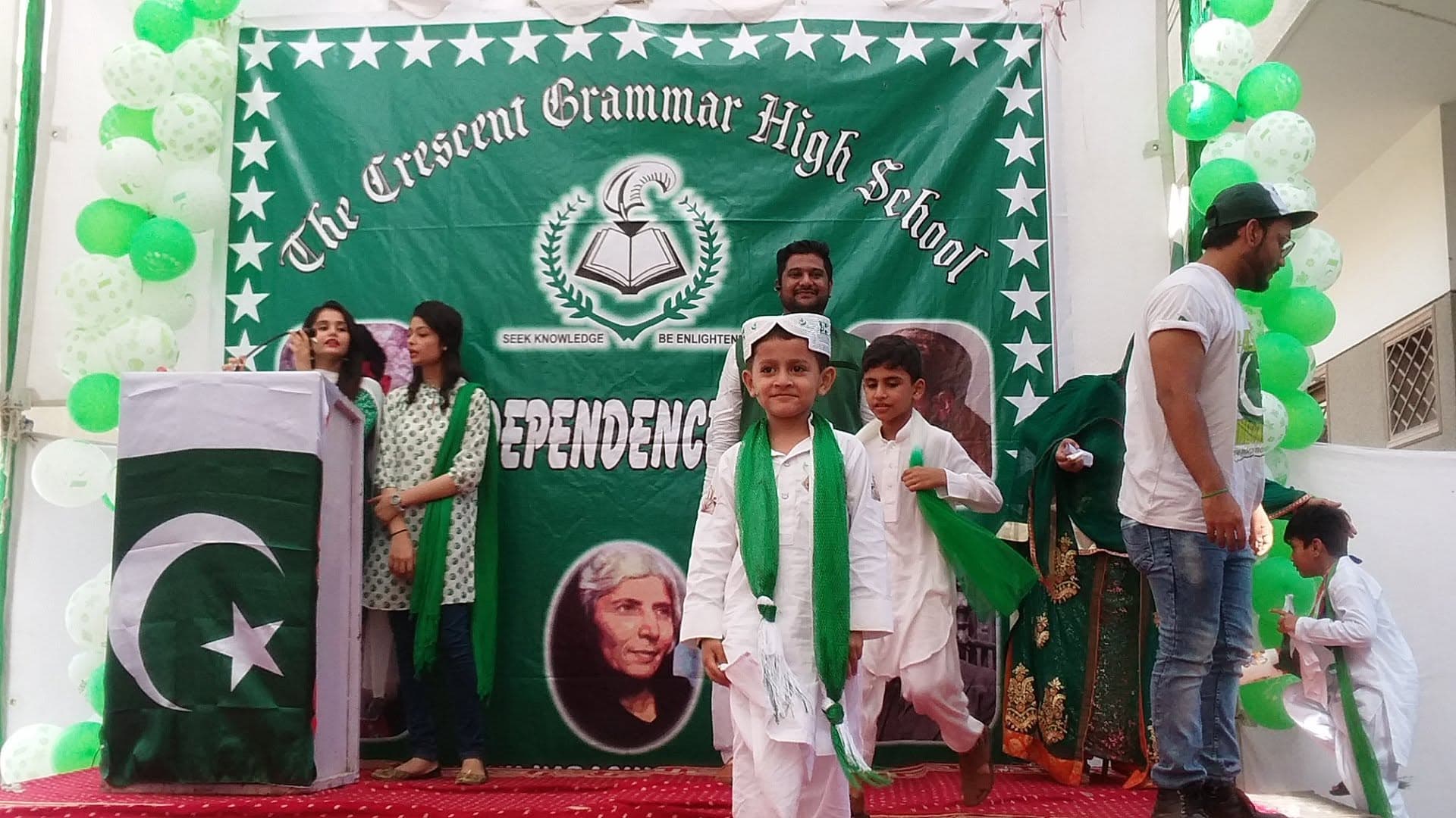The Crescent Grammar High School students celebrating in front of the school's real banner