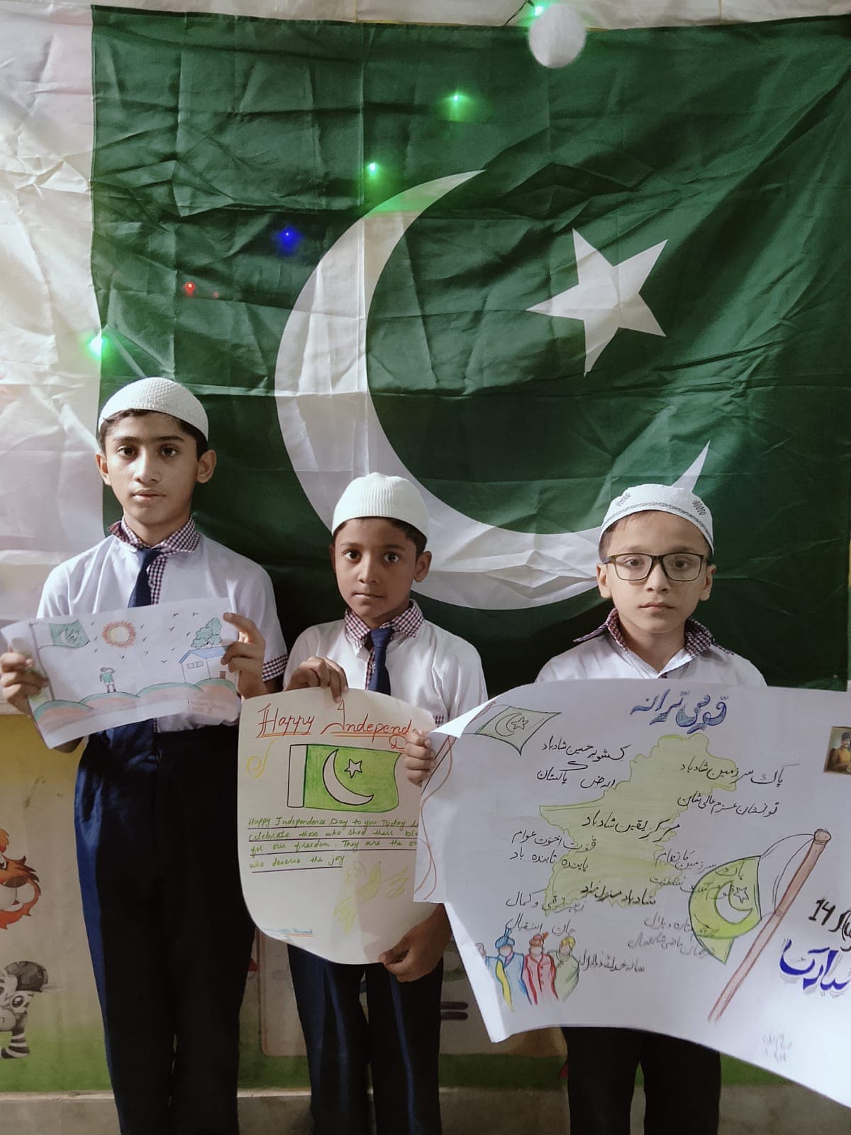 Students displaying their Pakistan-themed artwork