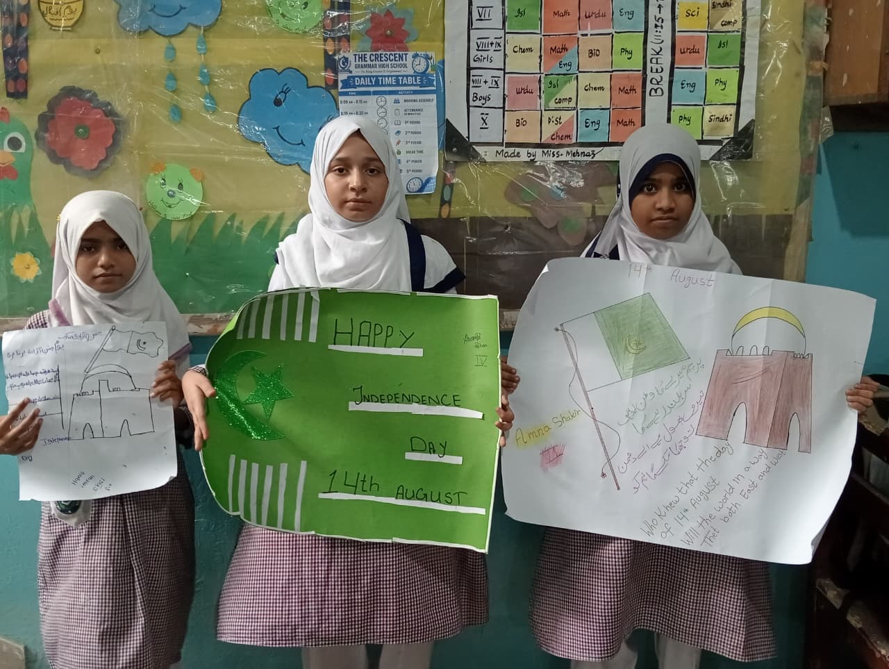 Students displaying Independence Day artwork